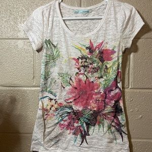 Maurice’s small white shirt with floral design on front
